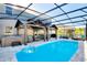 Inviting pool area featuring a screened enclosure, a hot tub, and a covered patio at 856 Sun Burst Rd, Winter Haven, FL 33880