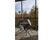 Relaxing screened balcony with table and chairs, overlooking wooded area at 8010 Tuscany Way # 5308, Davenport, FL 33896