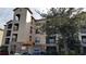 Three-story building exterior with balconies and parking at 8010 Tuscany Way # 5308, Davenport, FL 33896