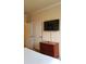 Bedroom with a dresser and mounted TV at 8010 Tuscany Way # 5308, Davenport, FL 33896