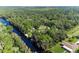Aerial view showing a canal-front property with lush vegetation at 6168 Arborea Dr, Lake Wales, FL 33898