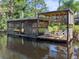 Relaxing dock with a covered patio and seating area at 6168 Arborea Dr, Lake Wales, FL 33898