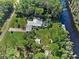 Aerial view showcasing house, expansive lot, and waterfront access at 6168 Arborea Dr, Lake Wales, FL 33898