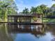 Waterfront dock with covered seating area and lattice walls at 6168 Arborea Dr, Lake Wales, FL 33898
