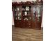 Large, wooden hutch with glass doors and ample storage space at 680 Augusta Rd, Winter Haven, FL 33884