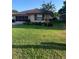Single-story home with a well-manicured lawn and attached garage at 680 Augusta Rd, Winter Haven, FL 33884