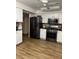 Modern kitchen with stainless steel appliances and white cabinets at 680 Augusta Rd, Winter Haven, FL 33884