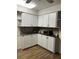 Bright eat-in kitchen with white cabinets, granite countertops, and modern appliances at 680 Augusta Rd, Winter Haven, FL 33884