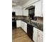 Modern kitchen featuring white shaker cabinets, granite countertops, and stainless steel appliances at 680 Augusta Rd, Winter Haven, FL 33884