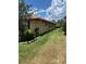 Landscaped side yard with lush greenery and a stone border at 680 Augusta Rd, Winter Haven, FL 33884