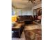Relaxing sunroom with leather furniture and a view of the backyard at 680 Augusta Rd, Winter Haven, FL 33884