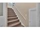 Staircase with brown carpeting leading to the upper level of the home at 1561 N Lake Howard Dr, Winter Haven, FL 33881