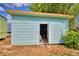 Light blue storage shed with open double doors at 4920 Old Lucerne Park Ne Rd, Winter Haven, FL 33881