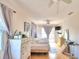 Spacious bedroom with a queen bed, dresser, and balcony access at 4920 Old Lucerne Park Ne Rd, Winter Haven, FL 33881