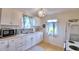 Clean kitchen with white cabinets, tile backsplash and microwave at 4920 Old Lucerne Park Ne Rd, Winter Haven, FL 33881