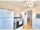 Cozy kitchen with white appliances and view into dining area at 4920 Old Lucerne Park Ne Rd, Winter Haven, FL 33881
