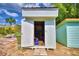 White storage shed with a partially open door, offering storage solutions at 4920 Old Lucerne Park Ne Rd, Winter Haven, FL 33881