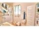 Clean bathroom with shower/tub combo, vanity, and linen closet at 4920 Old Lucerne Park Ne Rd, Winter Haven, FL 33881