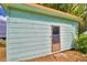 Light blue storage shed with a single door at 4920 Old Lucerne Park Ne Rd, Winter Haven, FL 33881