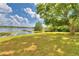 Expansive lake view with a dock, from a lush grassy area at 4920 Old Lucerne Park Ne Rd, Winter Haven, FL 33881