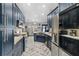 Modern kitchen with navy blue cabinets and stainless steel appliances at 1396 Lucerne Loop Ne Rd, Winter Haven, FL 33881
