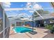 Screened-in pool with patio furniture and lake view at 1396 Lucerne Loop Ne Rd, Winter Haven, FL 33881