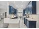 Modern kitchen with navy blue cabinets and white countertops at 1396 Lucerne Loop Ne Rd, Winter Haven, FL 33881
