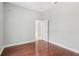 Simple bedroom with hardwood floors and door at 836 Summerfield Dr, Lakeland, FL 33803