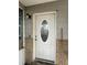 White front door with oval window and stone accents at 152 E Grove Dr, Haines City, FL 33844