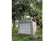 Gray storage shed with a roll-up door at 152 E Grove Dr, Haines City, FL 33844