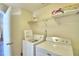 Laundry room with washer, dryer, and shelving for storage at 1608 Forest Hills Ln, Haines City, FL 33844