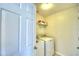 Laundry room with washer, dryer, and shelving for storage at 1608 Forest Hills Ln, Haines City, FL 33844