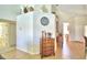 Bright entryway with tile flooring and wooden dresser at 1608 Forest Hills Ln, Haines City, FL 33844