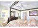 Spacious main bedroom with a four-poster bed and sitting area at 1608 Forest Hills Ln, Haines City, FL 33844