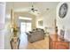 Spacious living room with gray sofas and sliding glass doors leading to the pool at 1608 Forest Hills Ln, Haines City, FL 33844