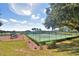 Community tennis courts and playground near a lake at 1608 Forest Hills Ln, Haines City, FL 33844