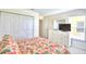 Bedroom with TV, dresser, and floral bedding at 1608 Forest Hills Ln, Haines City, FL 33844