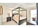 Main bedroom with canopy bed and ensuite bathroom access at 1608 Forest Hills Ln, Haines City, FL 33844
