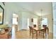 Bright dining room with table and chairs, view into kitchen at 1608 Forest Hills Ln, Haines City, FL 33844