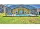 Home features a refreshing pool with a screened enclosure and lounge chairs at 1608 Forest Hills Ln, Haines City, FL 33844