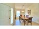 Bright dining room with a wooden table, chairs, and a chandelier at 1608 Forest Hills Ln, Haines City, FL 33844