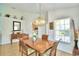 Dining room with a wooden table, chairs, and a view into the kitchen at 1608 Forest Hills Ln, Haines City, FL 33844