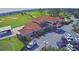 Aerial view of clubhouse, parking lot, and golf course at 1608 Forest Hills Ln, Haines City, FL 33844