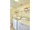 Laundry room with washer, dryer, and shelving for storage at 1608 Forest Hills Ln, Haines City, FL 33844