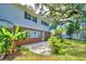 Spacious backyard with patio, lush landscaping, and storage shed at 1950 El Paso Trl, Bartow, FL 33830