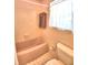 Pink bathroom with shower/tub combo and tiled flooring at 1950 El Paso Trl, Bartow, FL 33830