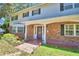 Front entrance of brick home with a covered porch and walkway at 1950 El Paso Trl, Bartow, FL 33830