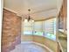 Kitchen with bay window and wood cabinets at 1950 El Paso Trl, Bartow, FL 33830