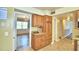 Bright kitchen featuring wood cabinets, granite countertops, and views into the dining room at 1950 El Paso Trl, Bartow, FL 33830