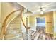 Elegant curved staircase with light wood railing and carpet at 1950 El Paso Trl, Bartow, FL 33830